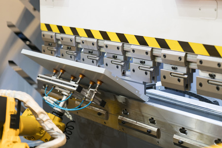 Robot arm bending metal sheet by sheet bending machine, cnc control metal sheet bending machine, high precision and high accuracy metal sheet bending machineの写真素材