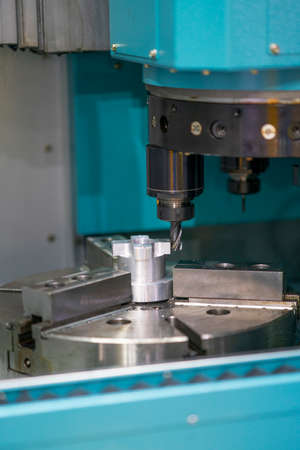 machining precision part by CNC machining centerの写真素材