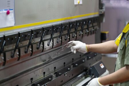 operator bending metal sheet by sheet bending machine 