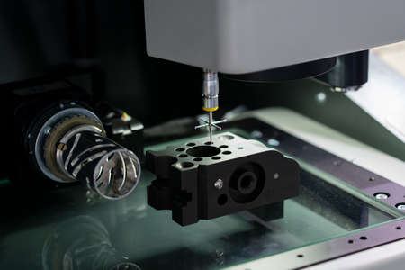 operator inspection high precision part by CMM coordinate measuring machine, CMM for inspection and reverse engineering by cnc programing control, high accuracy part verificationの写真素材