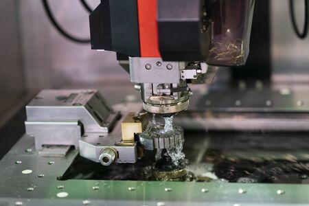CNC wire cut machine cutting high precision mold parts, cutting metal by electric discharge, high technology wirecut machine for precision manufacturingの写真素材