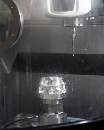 machining precision part by CNC machining centerの写真素材