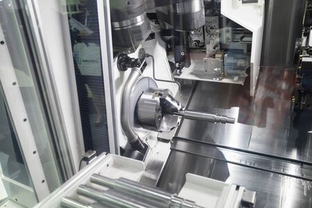 Operator machining automotive part by cnc turning machine, high accuracy with multi axis, multi...