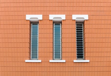 three window in a brick wall buildingの写真素材