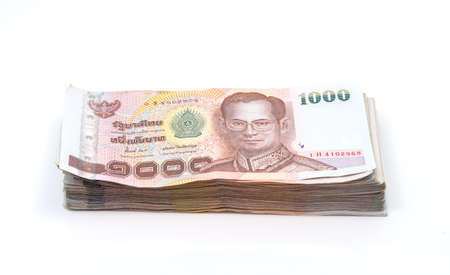 Stacks of 1000 baht bills isolated on white backgroundの写真素材