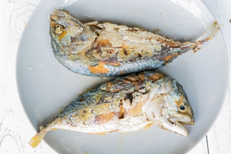 Two Fried Mackerel in plate on tableの写真素材