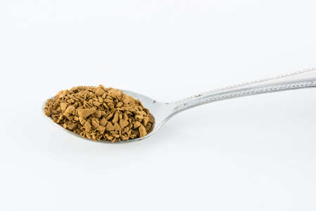 Spoon of coffee on a white background