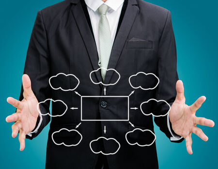 Businessman standing posture hand holding strategy flowchart isolated on over blue backgroundの写真素材