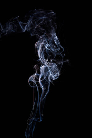 Abstract incense smoke isolated on black backgroundの写真素材
