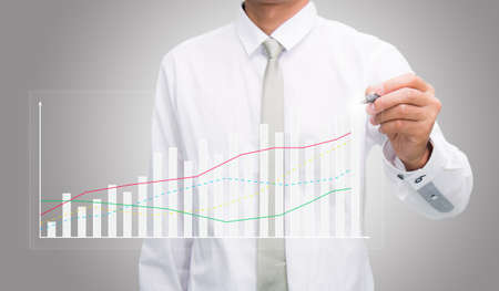 Businessman standing posture hand hold a pen isolated on gray backgroundの写真素材