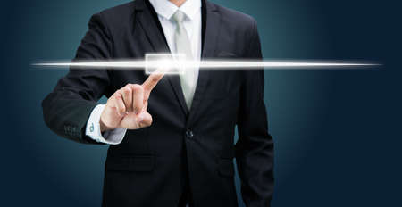 Businessman standing posture hand touching technology concept on dark backgroundの写真素材