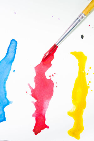 Paints and brushes color water on white backgroundの写真素材