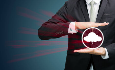 Businessman holding cloud computing network on dark backgroundの写真素材