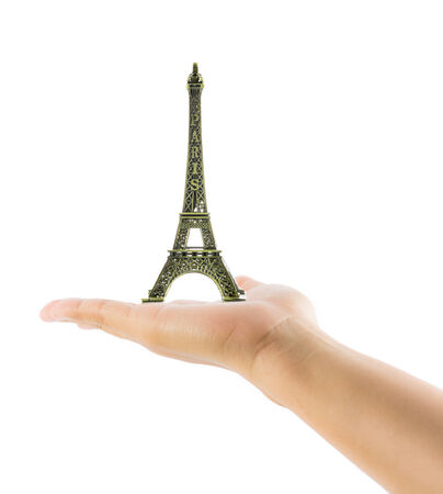 Hand holding Eiffel Tower Paris on over white backgroundの写真素材