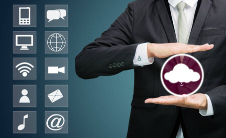 Businessman holding cloud computing network on dark backgroundの写真素材