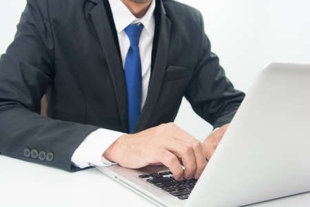Businessman Sitting Working on Laptop on white backgroundの写真素材