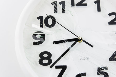 White clock is broken glass isolated on white background