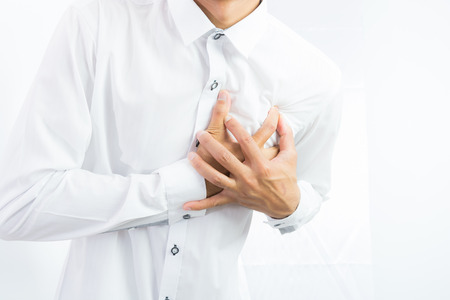 businessman having heart attack isolate on over white backgroundの写真素材
