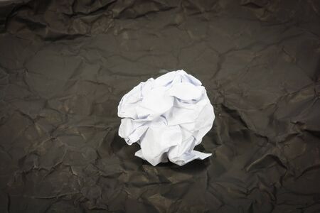 paper ball corrugate on black paper backgroundの写真素材