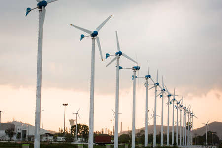 Wind power station against light sunsetの写真素材