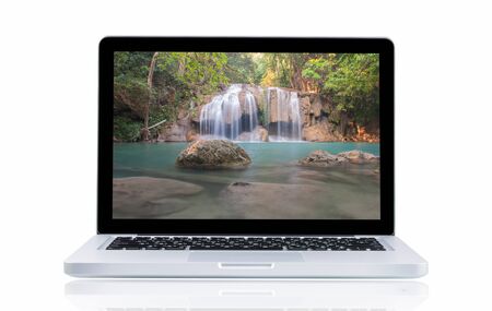 Laptop with landscape Erawan Waterfall at Kanchanaburi, Thailandの写真素材
