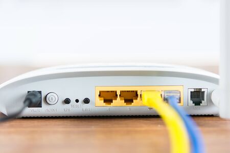 Wireless modem router network hub with cable connect on wooden table in the roomの写真素材