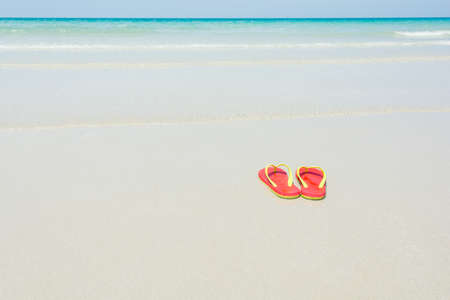 Beach, slippers on tropical beach in holiday at Thailandの写真素材