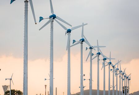 Wind power station against and light sunset, Power generation wind turbinesの写真素材