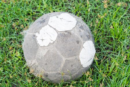 Very old football football on green grassの写真素材