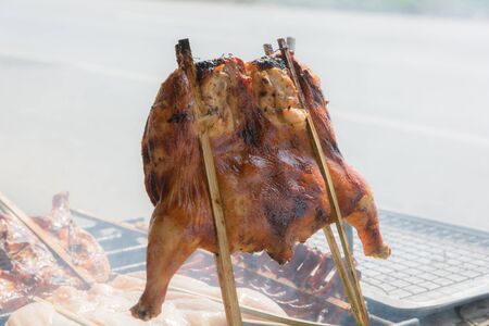 Grilled chicken on the grill roadside of Thailandの写真素材
