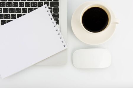 Notebook laptop and coffee cup on white tableの写真素材
