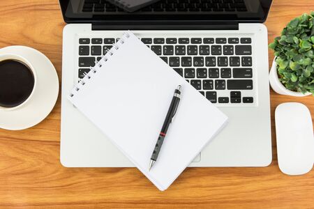 Notebook laptop and coffee cup on wood tableの写真素材