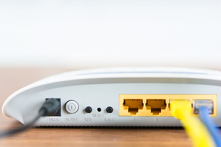 Wireless modem router network hub with cable connect on wooden table in the roomの写真素材