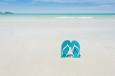 Beach, slippers on tropical beach in holiday at Thailandの写真素材