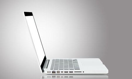 White Laptop with blank screen on gray backgroundの写真素材