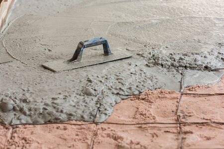 Plasterer concrete cement floor in the homeの写真素材