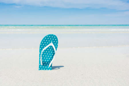 Beach, slippers on tropical beach in holiday at Thailandの写真素材