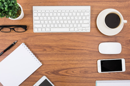 Business desk with a keyboard, mouse and pen on wooden tableの写真素材