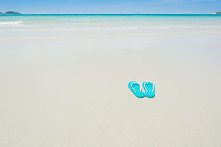 Beach, slippers on tropical beach in holiday at Thailandの写真素材