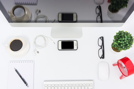 Business office top view computer monitor on white tableの写真素材