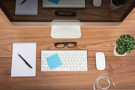 Business office top view computer monitor on wooden tableの写真素材