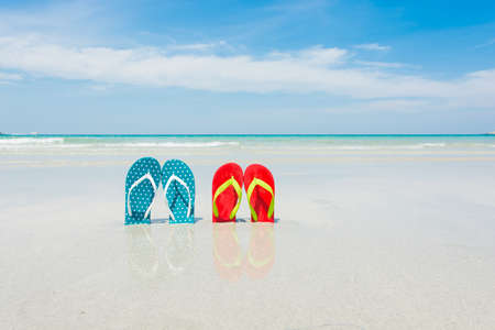 Beach, slippers on tropical beach in holiday at Thailandの写真素材