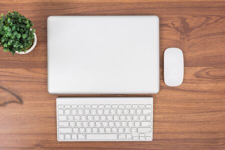 Top view close laptop or notebook workspace office on wooden tableの写真素材