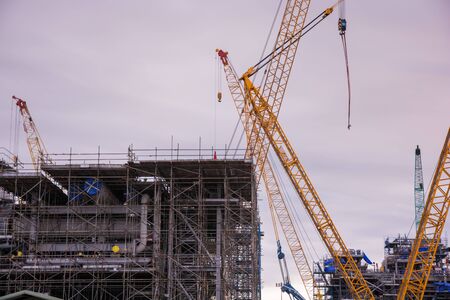 Industry crane and building construction site and blue skyの写真素材