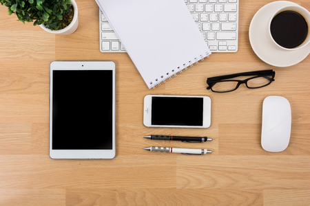 Business desk with a keyboard, mouse and pen on wooden tableの写真素材