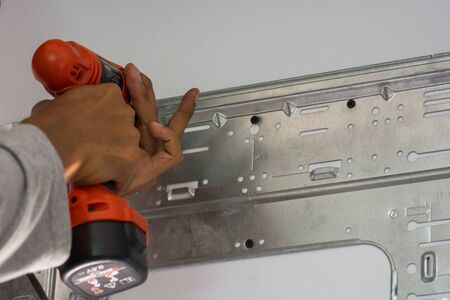 worker with rock drill the wall for air conditionerの写真素材