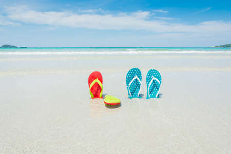 Beach, slippers on tropical beach in holiday at Thailandの写真素材