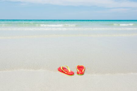 Beach, slippers on tropical beach in holiday at Thailandの写真素材