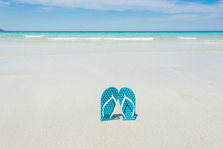 Beach, slippers on tropical beach in holiday at Thailandの写真素材