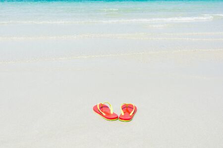 Beach, slippers on tropical beach in holiday at Thailandの写真素材